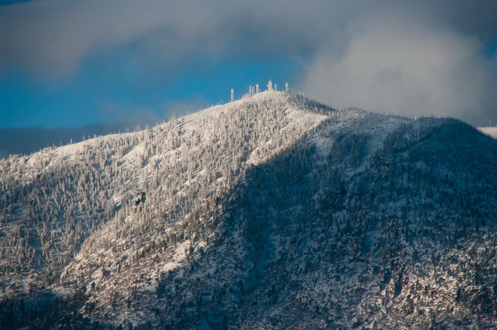 Communications towers on a snow-covered mountain summit